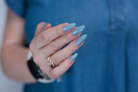 Hand with long nails and light baby blue manicure 스톡 사진