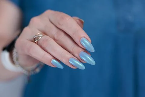 Hand with long nails and light baby blue manicure Stock Photos