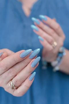 Hand with long nails and light baby blue manicure Stock Photos