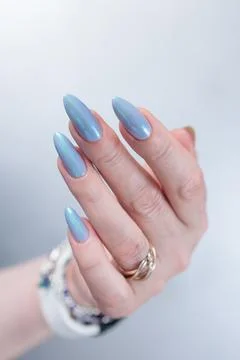 Hand with long nails and light baby blue manicure Stock Photos
