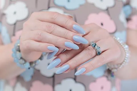 Hand with long nails and light baby blue manicure 스톡 사진