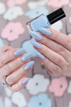 Hand with long nails and light baby blue manicure 库存照片