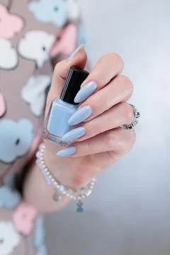 Hand with long nails and light baby blue manicure Stock Photos