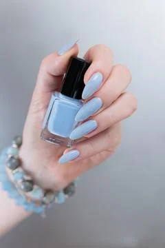 Hand with long nails and light baby blue manicure 스톡 사진