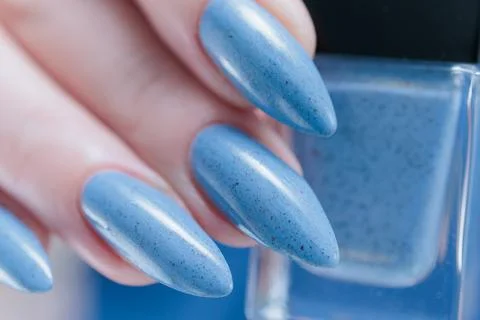 Hand with long nails and light baby blue manicure 스톡 사진