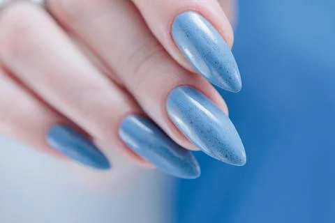 Hand with long nails and light baby blue manicure Stock Photos