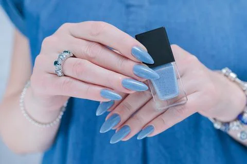 Hand with long nails and light baby blue manicure Stock Photos