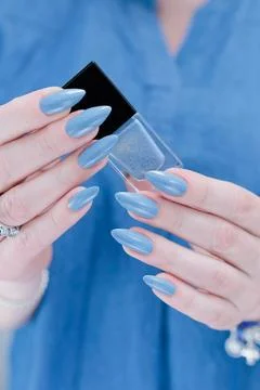 Hand with long nails and light baby blue manicure Stock Photos