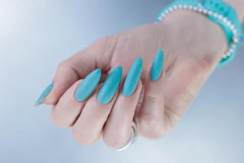 Hand with long nails and light baby blue manicure Stock-Fotos