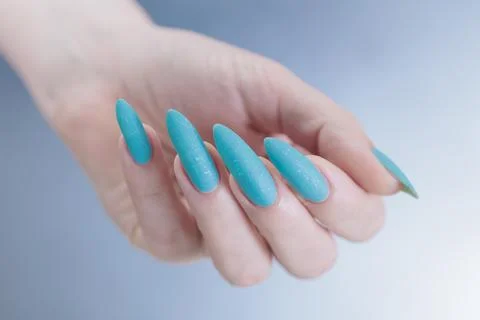 Hand with long nails and light baby blue manicure Stock Photos