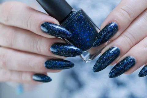 Hand with long nails black and dark blue manicure 库存照片