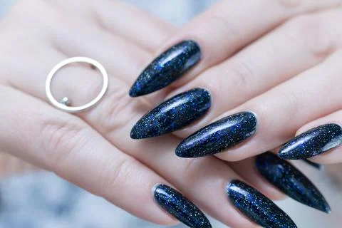 Hand with long nails black and dark blue manicure 스톡 사진