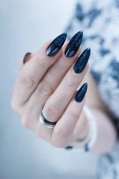 Hand with long nails black and dark blue manicure 스톡 사진