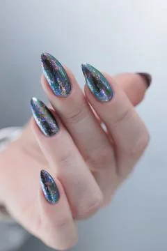 Hand with long nails gray metallic manicure Photos