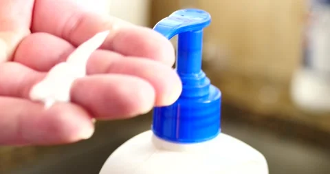 Hand lotion being placed on hand close up fingers Stock Footage 150718765