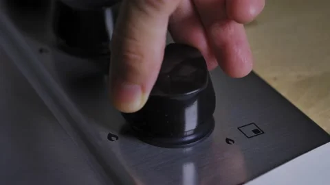 Hand lower flame of stove in the house. To use less gas to cook, cook on low  Stock Footage 212048699