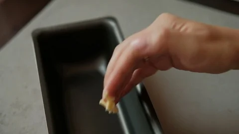 Hand lubricates the baking dish fat Stock Footage 79526841