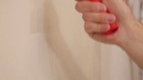 Hand is lubricating wall on glue with roller Stock Footage 95527843