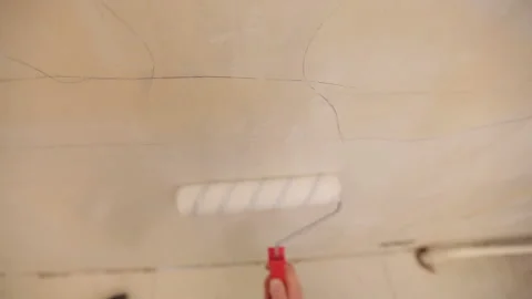Hand is lubricating wall on glue with roller Stock Footage 95527860