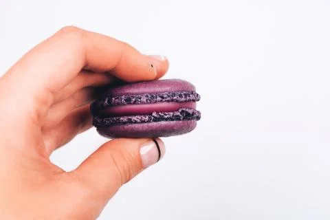 Hand with macaron Stock Photos