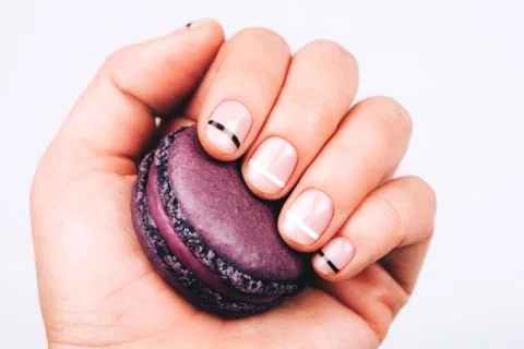 Hand with macaron Stock Photos