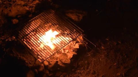 Hand made barbecue with grill is burning at night  Stock Footage 77845629