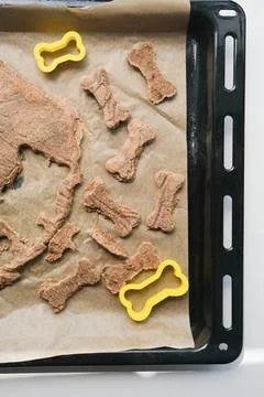 Hand made bone shaped dog biscuits on tray Stock Photos
