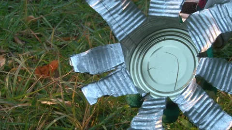 Hand made braizer from a cut a tin can of canned food on green grass background Video stock 62792235