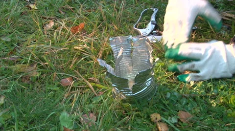 Hand made braizer from a cut a tin can of canned food on green grass background Stock Footage 62792243