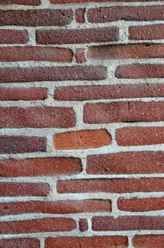 Hand made brick wall made from narrow long bricks Stock Photos