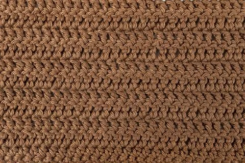 Hand made crochet pattern, textured brown abstract background, with horizon.. Foto stock