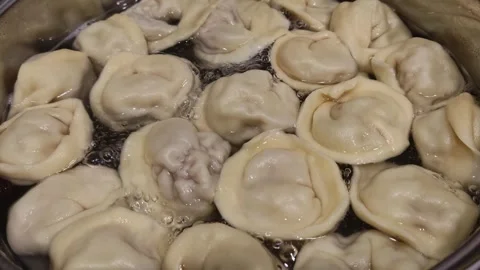 Hand-made dumplings are cooked in boiling water, close-up. Stock Footage 263187052