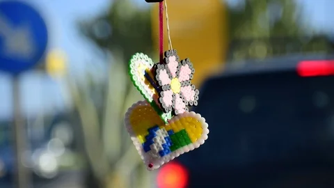 Hand-made gift hanging from car mirror 動画素材 114570588