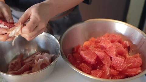 Hand-made grapefruit extract, put the pieces of skin in a stainless steel bowl Stock Footage 126499293