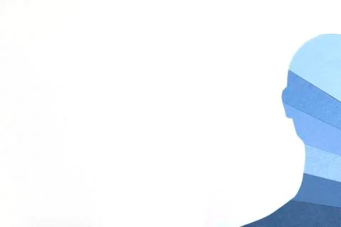 The hand made human face half cut out of paper in all shades of blue Stock Photos
