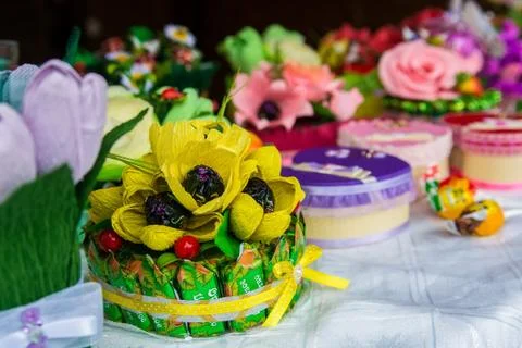 Hand-made present of candy and artificial flowers Stock Photos