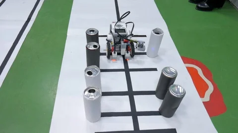 Hand made robot moves through a desk with an obstacles at a robot competitions. Stock Footage 85716422