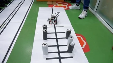 Hand made robot moves through a desk with an obstacles at a robot competitions. Stock Footage 85716504