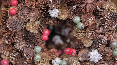 Hand made rustic wreath made of pine cones and berries. New year's decorations Stock Footage 305751250