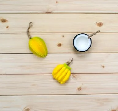 Hand made soap in the shape of tropic fruits mini bananas, carambola and half Stock Photos