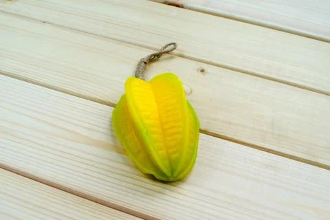 Hand made soap in the shape of tropic fruit carambola isolated on wood backgr Stock Photos