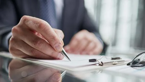 Hand makes notes on a paper notebook, close-up 스톡 사진