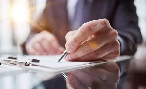 Hand makes notes on a paper notebook, close-up Stock Photos