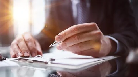 Hand makes notes on a paper notebook, close-up 스톡 사진