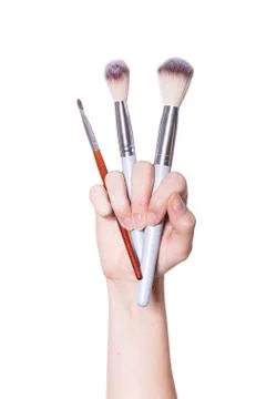 Hand with makeup brushes Stock Photos