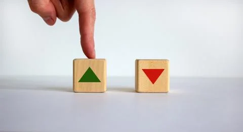 Hand making a choice between two cubes on white background. Wooden cubes chan Stock Photos