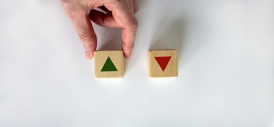Hand making a choice between two cubes on white background. Wooden cubes chan Stock Photos