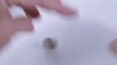 Hand making coin rotate until it falls and stops Stock Footage 36157151