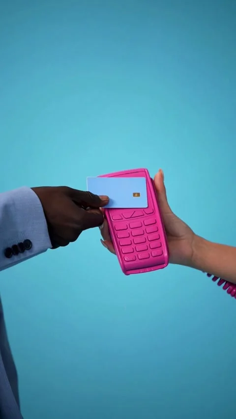 Hand making a contactless payment with pink card terminal Video stock 331771244