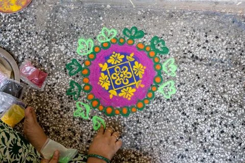 Hand Making Decorative Rangoli Pattern With Bright Festival Colors at Home Stock Photos